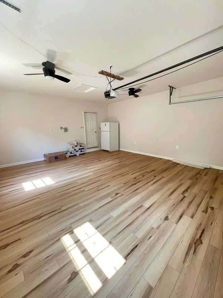 Another view of the finished room, showing the painted walls and ceiling and the new flooring.