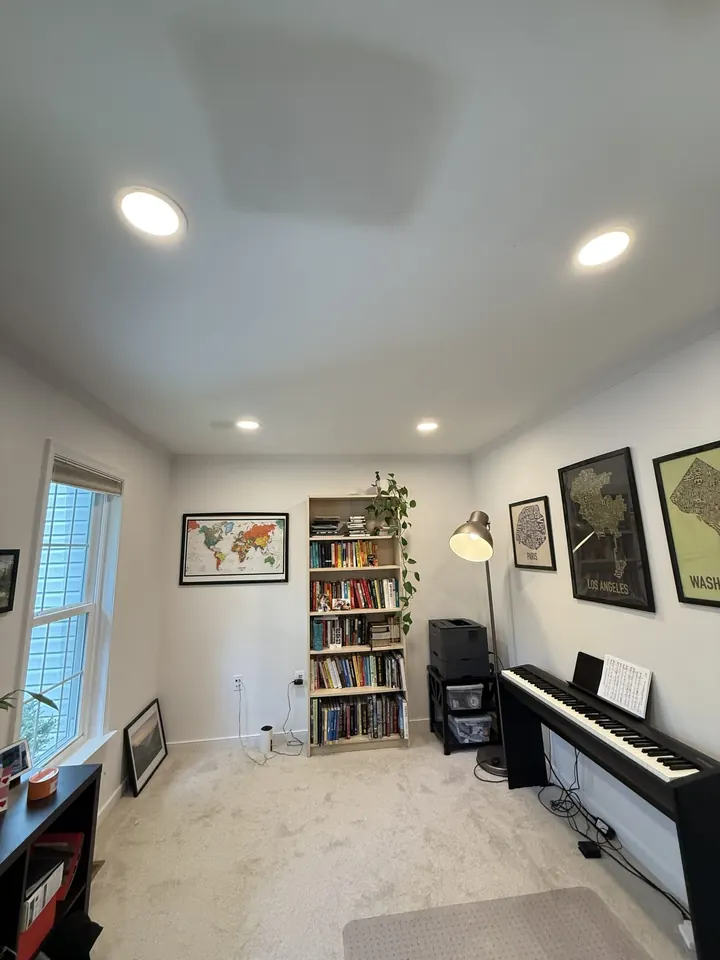 The same ceiling closed, finished, and painted around the installed recessed light fixtures.