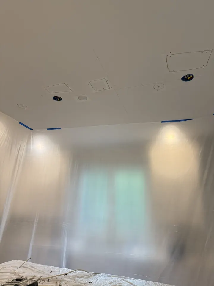 Kitchen ceiling with drywall patches set in around the light fixture openings before finishing.